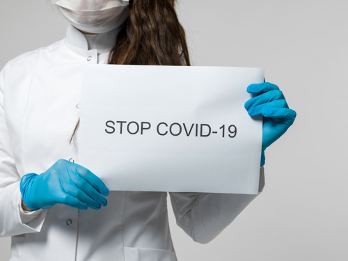 Covid-19 Written on Paper in Medical Staff hands